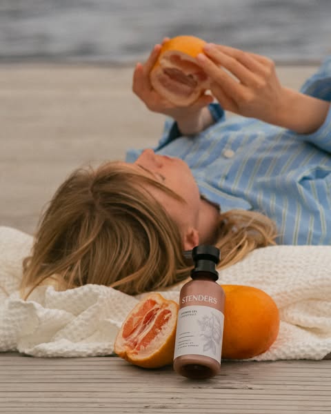 STENDERS Grapefruit shower gel on a lakeside dock